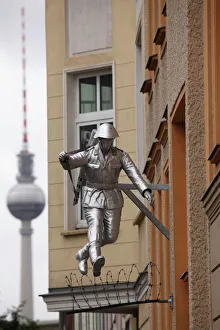 Berlin Television Tower (Fernsehturm) and sculpture of a soldier jumping the Berlin Wall at Bernauerstrasse, Berlin Berlin Television Tower (Fernsehturm) and sculpture of a soldier jumping the Berlin Wall at Bernauerstrasse, Berlin