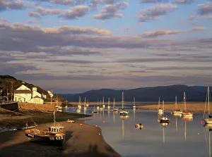 Boats in the evening sun at low tide on the Dovey Estuary Boats in the evening sun at low tide on the Dovey Estuary