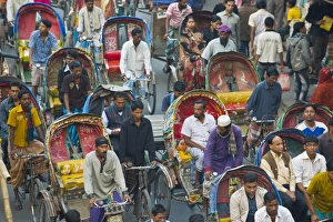 Busy rickshaw traffic on a street crossing in Dhaka, Bangladesh, Asia Busy rickshaw traffic on a street crossing in Dhaka, Bangladesh, Asia