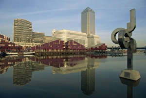 Canary Wharf and modern art sculpture reflected in pond, Docklands, London Canary Wharf and modern art sculpture reflected in pond, Docklands, London