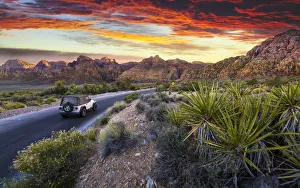 Car driving through The Red Rock Canyon National Recreation Area at sunset, Las Vegas Car driving through The Red Rock Canyon National Recreation Area at sunset, Las Vegas