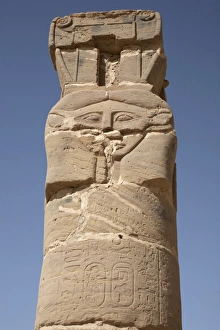A carved pillar stands at the entrance to the Temple A carved pillar stands at the entrance to the Temple