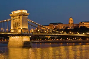 Prints of The Chain Bridge (Szechenyi Lanchid), over the River Danube, illuminated at sunset with the Hungarian National Gallery also lit, behind, Budapest, Hungary, Europe Hungary Prints: The Chain Bridge Print: Budapest Sunset Illumination