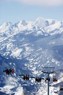 A chairlift taking skiers to the back bowls of Vail ski resort A chairlift taking skiers to the back bowls of Vail ski resort