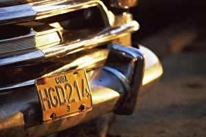 Close-up of chrome bumper and yellow car number plate in morning light Close-up of chrome bumper and yellow car number plate in morning light
