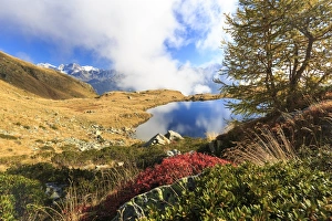Clouds on peaks of Bernina Group reflected in Lake Arcoglio, Val Torreggio, Malenco Valley Clouds on peaks of Bernina Group reflected in Lake Arcoglio, Val Torreggio, Malenco Valley