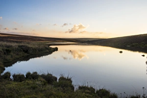 Clouds reflecting in a little lake at sunset, Nyika National Park, Malawi, Africa Clouds reflecting in a little lake at sunset, Nyika National Park, Malawi, Africa