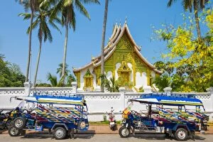 Images Dated 14th May 2015: Colorful tuk-tuks in front of Haw Pha Bang temple on the grounds of the Royal Palace
