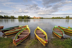 Prints of Colourful rowing boats and Trakai Castle, Trakai, near Vilnius, Lithuania, Baltic States, europe Lithuania Prints: Colourful rowing boats and Trakai Castle Print