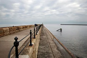 Couple walking on the North Pier at Tynemouth, North Tyneside, Tyne and Wear, England, United Kingdom, Europe Couple walking on the North Pier at Tynemouth, North Tyneside, Tyne and Wear, England, United Kingdom, Europe
