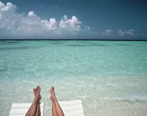 Couples legs on a beach, Maldives, Indian Ocean, Asia Couples legs on a beach, Maldives, Indian Ocean, Asia