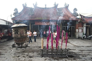 Devotional incense sticks burning outside the Goddess of Mercy Chinese temple Devotional incense sticks burning outside the Goddess of Mercy Chinese temple