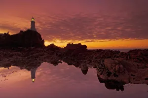 Corbiere Lighthouse Jersey Prints: Dramatic sunset and low tide, Corbiere lighthouse, St. Ouens, Jersey, Channel Islands