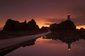 UK Coastal Scenes Prints: Dramatic sunset, low tide, Corbiere lighthouse, St. Ouens, Jersey, Channel Islands