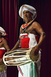 Drummer in a Pancha Thuryas Kandyan dance orchestra at tourist show in the Kandyan Arts Association Hall, Kandy, Sri Drummer in a Pancha Thuryas Kandyan dance orchestra at tourist show in the Kandyan Arts Association Hall, Kandy, Sri