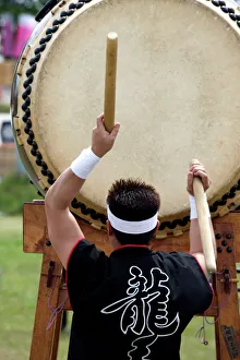 Drummer performing on a Japanese taiko drum at a festival in Kanagawa, Japan, Asia Drummer performing on a Japanese taiko drum at a festival in Kanagawa, Japan, Asia