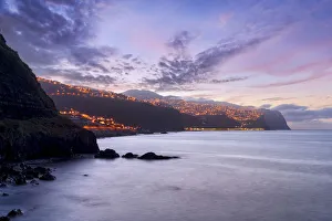 Dusk over the illuminated coastal village of Ponta do Sol, Madeira island, Portugal Dusk over the illuminated coastal village of Ponta do Sol, Madeira island, Portugal