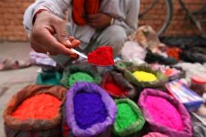 A dye trader offers his brightly coloured wares in a roadside stall in Kathmandu A dye trader offers his brightly coloured wares in a roadside stall in Kathmandu