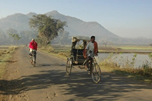 Early morning rickshaw wallahs pass each other in rural countryside near Baliguda Early morning rickshaw wallahs pass each other in rural countryside near Baliguda
