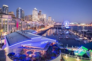 Elevated view of Seattle skyline and restaurants in Bell Harbour Marina at dusk, Belltown District