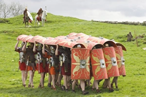 Ermine Street Guard advancing with protective shields, cavalry in attendance Ermine Street Guard advancing with protective shields, cavalry in attendance