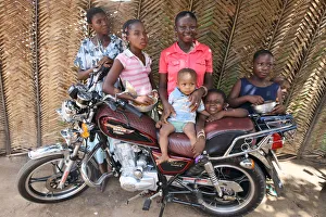 Family around a motocycle, Lome, Togo, West Africa, Africa Family around a motocycle, Lome, Togo, West Africa, Africa