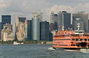 The famous orange Staten Island Ferry approaches lower Manhattan, New York The famous orange Staten Island Ferry approaches lower Manhattan, New York