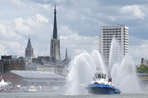 Fires boats on River Seine and Rouen cathedral behind, Rouen, Normandy, France, Europe Fires boats on River Seine and Rouen cathedral behind, Rouen, Normandy, France, Europe