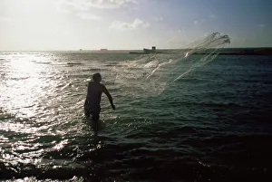 Fisherman casting net, Cuba, West Indies, Central America Fisherman casting net, Cuba, West Indies, Central America