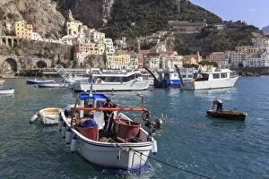 Amalfi Harbour Collection: Fisherman in fishing boat in Amalfi harbour, from quayside with view towards Amalfi town