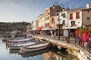 Images Dated 3rd September 2015: Fishing boats at the harbour, restautants and street cafes on the promenade, Cassis