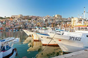 Fishing boats moored in the harbour surrounded by blue sea and the old town, Sciacca Fishing boats moored in the harbour surrounded by blue sea and the old town, Sciacca