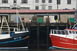 Fishing boats in Whitby harbour with the famous Magpie Cafe in the background Fishing boats in Whitby harbour with the famous Magpie Cafe in the background