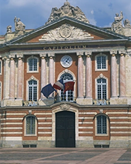 Flags flying below a clock on the Capitole building in Toulouse, Haute Garonne Flags flying below a clock on the Capitole building in Toulouse, Haute Garonne
