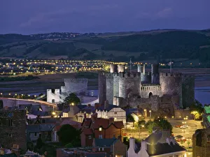 Floodlit Conwy Castle, UNESCO World Heritage Site, overlooking the town with the River Floodlit Conwy Castle, UNESCO World Heritage Site, overlooking the town with the River