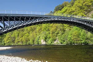 Fly fisherman near the Telford iron bridge, built in 1815, across the River Spey Fly fisherman near the Telford iron bridge, built in 1815, across the River Spey