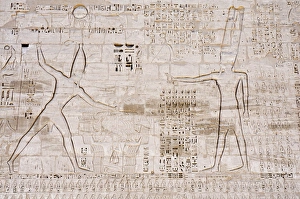 Giant relief of Rameses III smiting enemies before Amen-Ra, South Tower of the first Pylon Giant relief of Rameses III smiting enemies before Amen-Ra, South Tower of the first Pylon