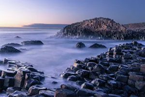The Giants Causeway rises out of the Atlantic late at night as the last light of The Giants Causeway rises out of the Atlantic late at night as the last light of