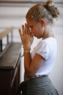Girl praying in church, Saint Nicolas de Veroce, Haute Savoie, France, Europe Girl praying in church, Saint Nicolas de Veroce, Haute Savoie, France, Europe
