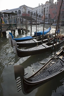 Gondolas moored on Grand Canal near Rialto Bridge, Venice, UNESCO World Heritage Site Gondolas moored on Grand Canal near Rialto Bridge, Venice, UNESCO World Heritage Site