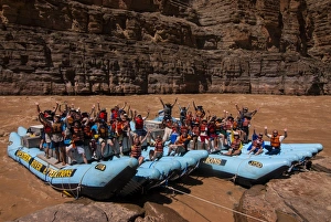 Happy tourists on two rafts celebrating, in the beautiful scenery of the Colorado River in the Grand Canyon, Arizona Happy tourists on two rafts celebrating, in the beautiful scenery of the Colorado River in the Grand Canyon, Arizona