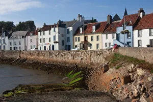 Harbour wall, low tide and pastel coloured cottages, St. Monan, East Coast, Fife, Scotland, United Kingdom, Europe Harbour wall, low tide and pastel coloured cottages, St. Monan, East Coast, Fife, Scotland, United Kingdom, Europe