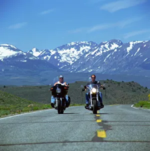 Harley Davidson bikers with snow-capped mountains in background, United States of America Harley Davidson bikers with snow-capped mountains in background, United States of America