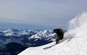 A highly skilled skier making a very fast descent of the extremely steep off-piste run known as Cosmiques Couloir A highly skilled skier making a very fast descent of the extremely steep off-piste run known as Cosmiques Couloir