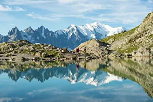 Hikers and the summit of Mont Blanc reflected in Lac Blanc on the Tour du Mont Blanc Hikers and the summit of Mont Blanc reflected in Lac Blanc on the Tour du Mont Blanc