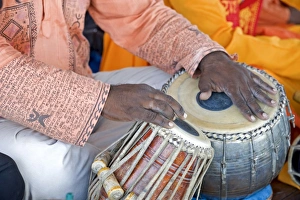 Hindu musician playing the tabla (drums) with typical black spot made from a mixture of gum Hindu musician playing the tabla (drums) with typical black spot made from a mixture of gum