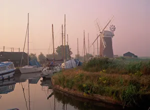 Horsey Wind Pump and boats moored on the Norfolk Broads at dawn, Norfolk Horsey Wind Pump and boats moored on the Norfolk Broads at dawn, Norfolk