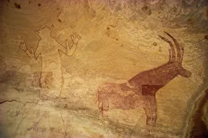 Huge painting of god figure and sable antelope on rock wall, Tassili Plateau Huge painting of god figure and sable antelope on rock wall, Tassili Plateau