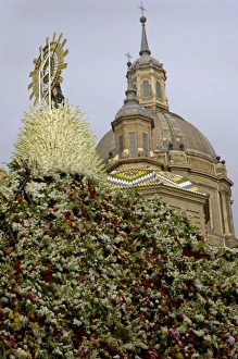 The icon of Nuestra Senora del Pilar covered in flowers The icon of Nuestra Senora del Pilar covered in flowers