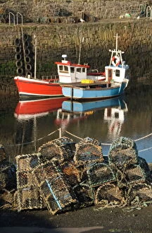 Images Dated 9th May 2009: Lobster creels in the foreground with fishing boats in the harbour, Crail
